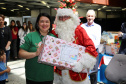 Alessandra recebe do Papai Noel presente que simboliza doações. Foto: Sanepar
